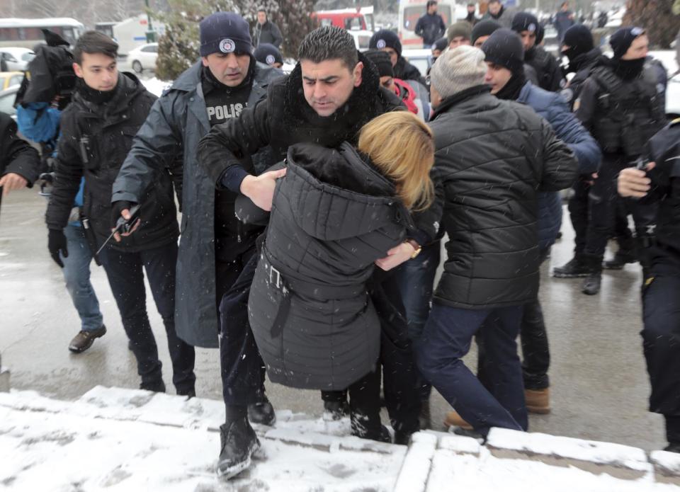 Riot police detain a protester as dozens of demonstrators gathered in front of Turkey's parliament to protest proposed amendments to the country's constitution that would hand sweeping executive powers to President Recep Tayyip Erdogan's largely ceremonial presidency, in Ankara, Turkey, Monday. Jan. 9, 2017. Parliament is kicking off a debate Monday on a set of draft amendments.(AP Photo/Burhan Ozbilici)