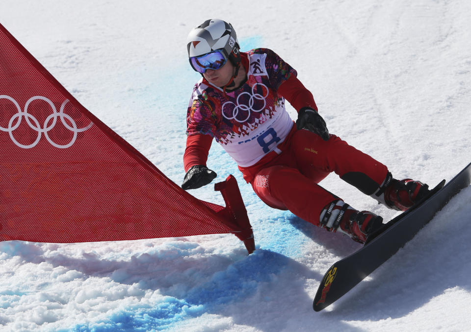 Switzerland's Nevin Galmarini competes during men's snowboard parallel giant slalom heats at the Rosa Khutor Extreme Park, at the 2014 Winter Olympics, Wednesday, Feb. 19, 2014, in Krasnaya Polyana, Russia. (AP Photo/Sergei Grits)