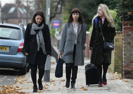 Sisters Francesca (C) and Elisabetta Grillo (L) arrive at Isleworth Crown Court in west London December 4, 2013. REUTERS/Luke MacGregor