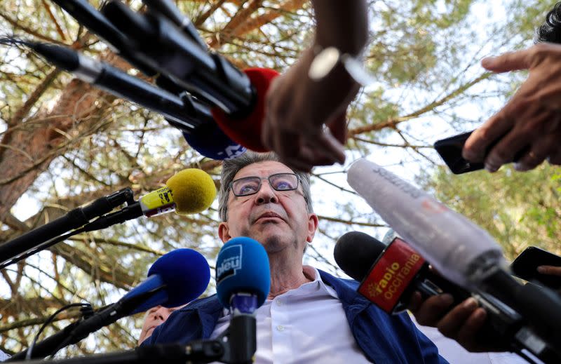 FILE PHOTO: French far-left leader Jean-Luc Melenchon speaks to the media ahead of employees of Airbus walk towards Toulouse-Blagnac airport during a strike called by unions in Blagnac