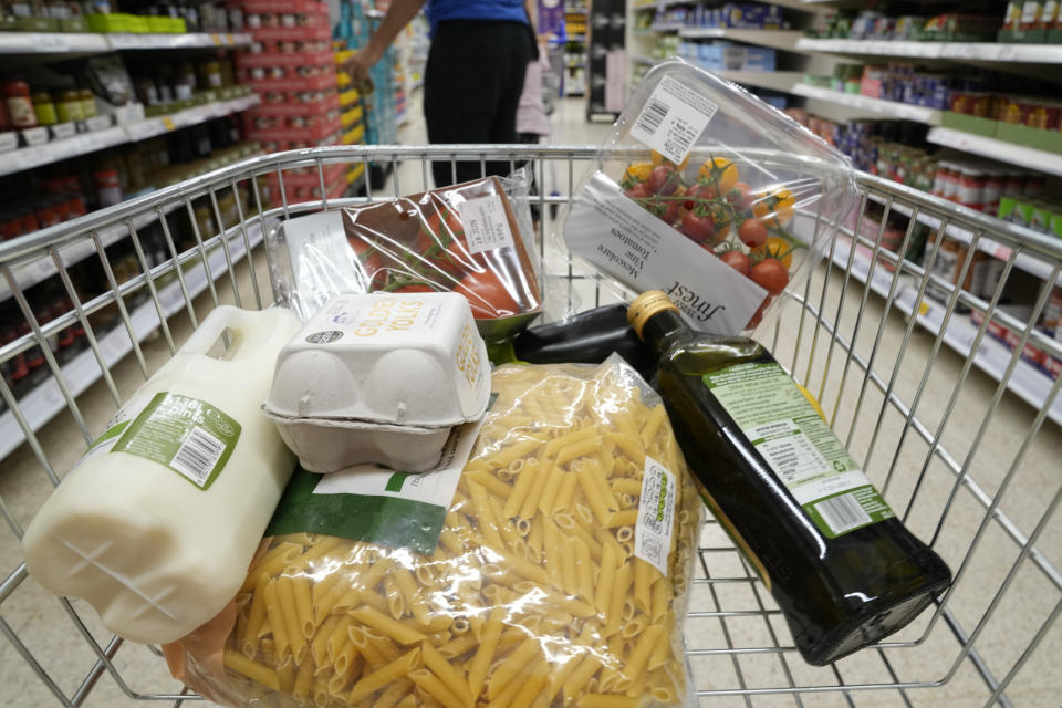 A basket of groceries a trolly at a supermarket in London, Saturday, June 10, 2023. High food prices are pinching households across Europe, where food inflation is outpacing other major economies like the U.S., Japan and Canada. Some governments have responded with formal price controls or loose agreements with supermarkets to keep costs down. (AP Photo/Alastair Grant)