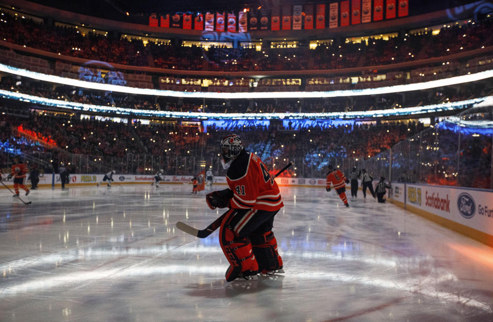 FILE - In this Feb. 20, 2020, file photo, Edmonton Oilers goalie Mike Smith warms up for the team's NHL hockey game against the Winnipeg Jets in Edmonton, Alberta. Deputy Commissioner Bill Daly told The Associated Press on Sunday, July 5, that the NHL and NHL Players’ Association have agreed on protocols to resume the season. Daly said the sides are still negotiating a collective bargaining agreement extension. A CBA extension is still crucial to the process. (Jason Franson/The Canadian Press via AP, File)