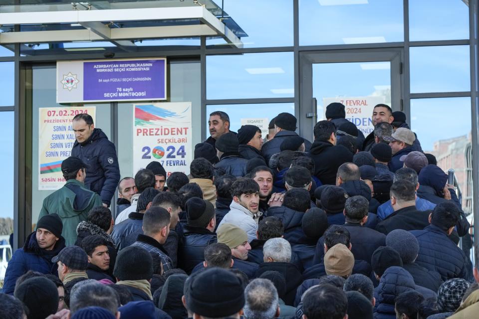 People line up to attend voting at a polling station during presidential election in Fuzuli in Karabakh region, Azerbaijan, Wednesday, Feb. 7, 2024. Azerbaijanis are voting Wednesday in an election almost certain to see incumbent President Ilhan Aliyev chosen to serve another seven-year term. (AP Photo/Sergei Grits)