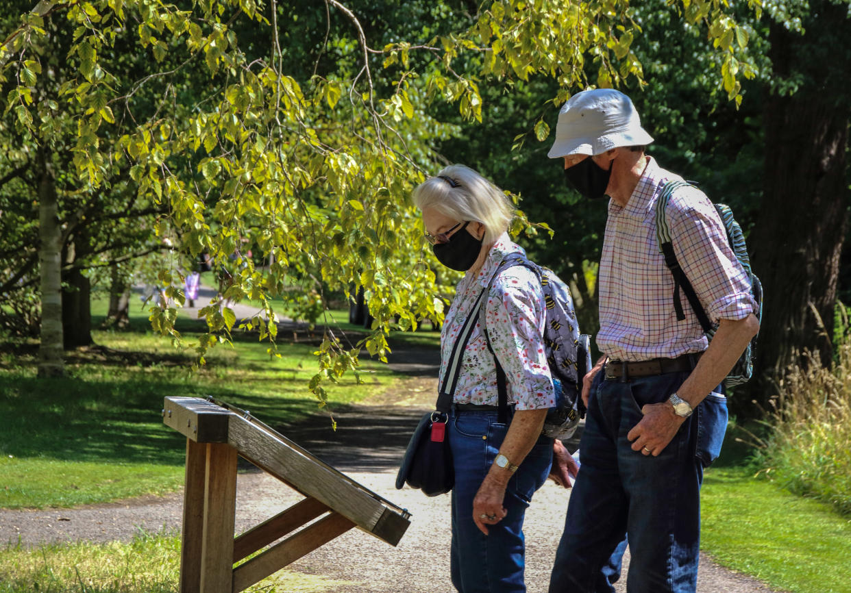  An elderly couple wearing face masks walk along the park. People wear a variety of facemasks outdoors in Cambridge, although they are only mandatory on public transport and inside shops and public spaces at the moment in the UK. (Photo by Keith Mayhew / SOPA Images/Sipa USA) 