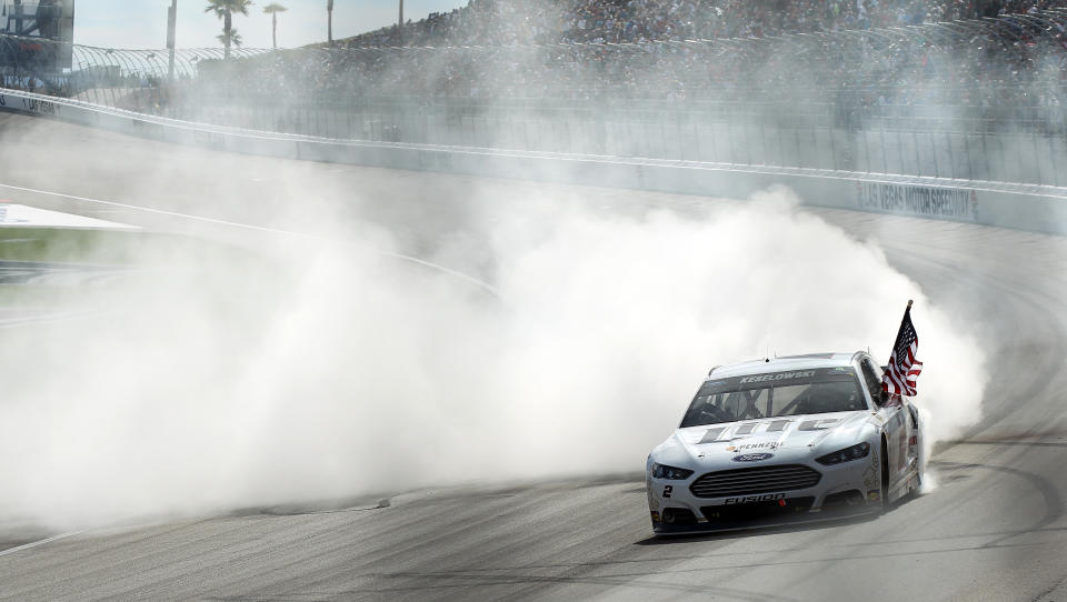 Brad Keselowski does a burnout after winning a NASCAR Sprint Cup Series auto race Sunday, March 9, 2014, in Las Vegas. (AP Photo/Isaac Brekken)