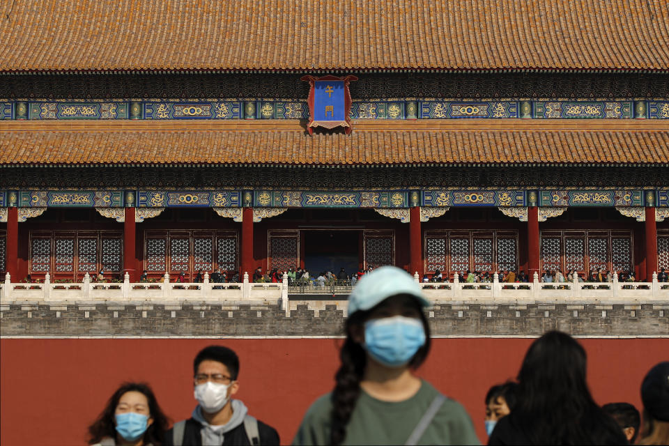Tourists wearing face masks to help curb the spread of the coronavirus visit Forbidden City in Beijing, Sunday, Oct. 25, 2020. With the outbreak of COVID-19 largely under control within China's borders, the routines of normal daily life have begun to return for its citizens. (AP Photo/Andy Wong)