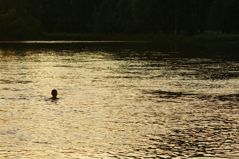 Silhouette of a boy in river