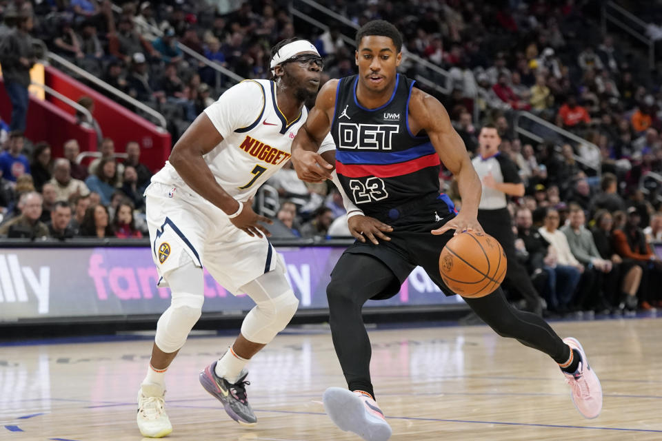 Detroit Pistons guard Jaden Ivey (23) drives as Denver Nuggets guard Reggie Jackson (7) defends during the first half of an NBA basketball game, Monday, Nov. 20, 2023, in Detroit. (AP Photo/Carlos Osorio)