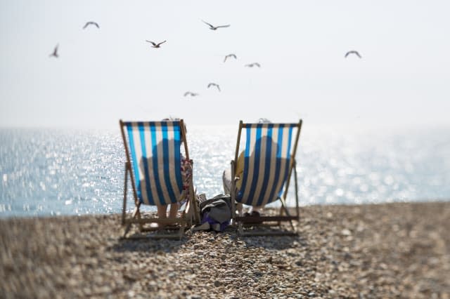 Two people on deckchairs and seagulls