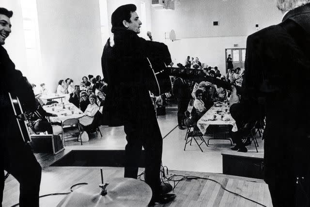 <p>Alamy</p> Johnny Cash performing at Lansing Women's Prison Kansas in 1971.