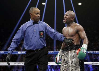 Floyd Mayweather speaks to referee Kenny Bayless after claiming Marcos Maidana bit him. (AP)