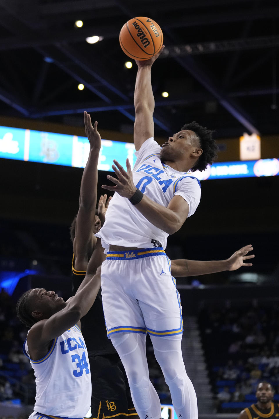 UCLA guard Jaylen Clark (0) grabs a rebound during the first half of the team's NCAA college basketball game against Long Beach State on Friday, Nov. 11, 2022, in Los Angeles. (AP Photo/Marcio Jose Sanchez)