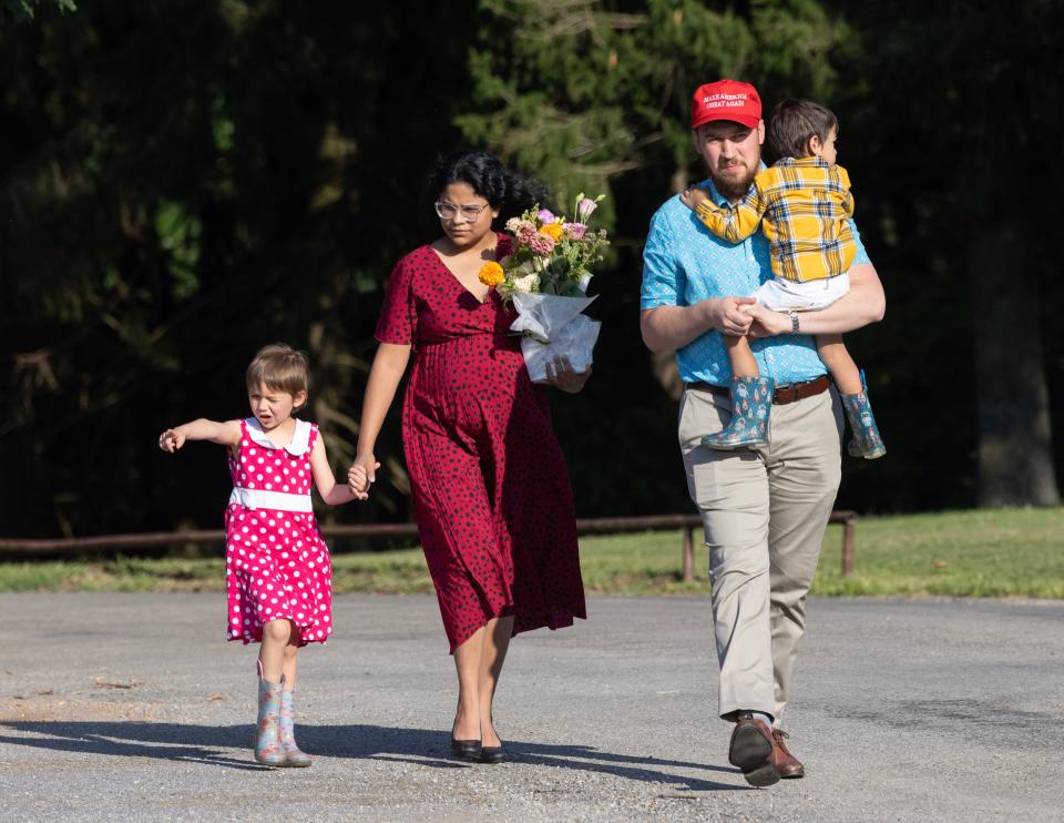 An unidentified family walks towards the calling hours for Corey Comperatore at Laube Hall in Freeport Park where the calling hours took place Thursday, July 18th in Freeport Pennsylvania. Comperatore died shielding his family from a would-be assassin's bullets that were aimed at former President Donald Trump during a rally Saturday.