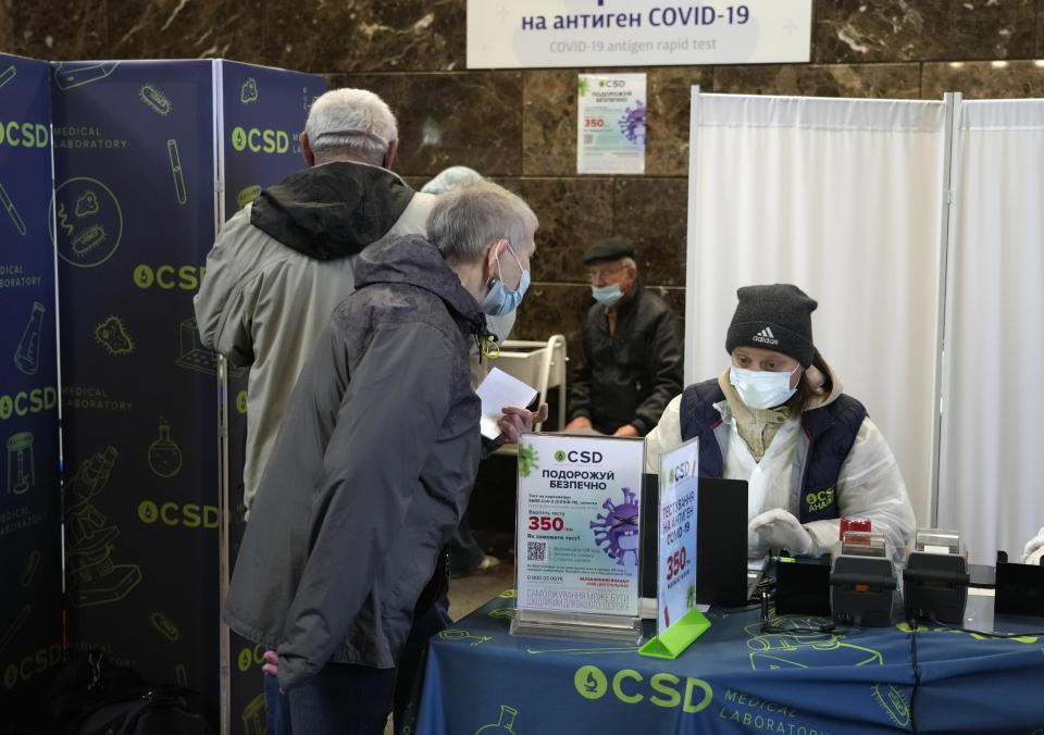 People take an antigen-test for COVID-19 at a train station in Kyiv, Ukraine, Tuesday, Oct. 26, 2021. Coronavirus infections and deaths in Ukraine have surged to all-time highs amid a laggard pace of vaccination, which is one of the lowest in Europe. (AP Photo/Efrem Lukatsky)