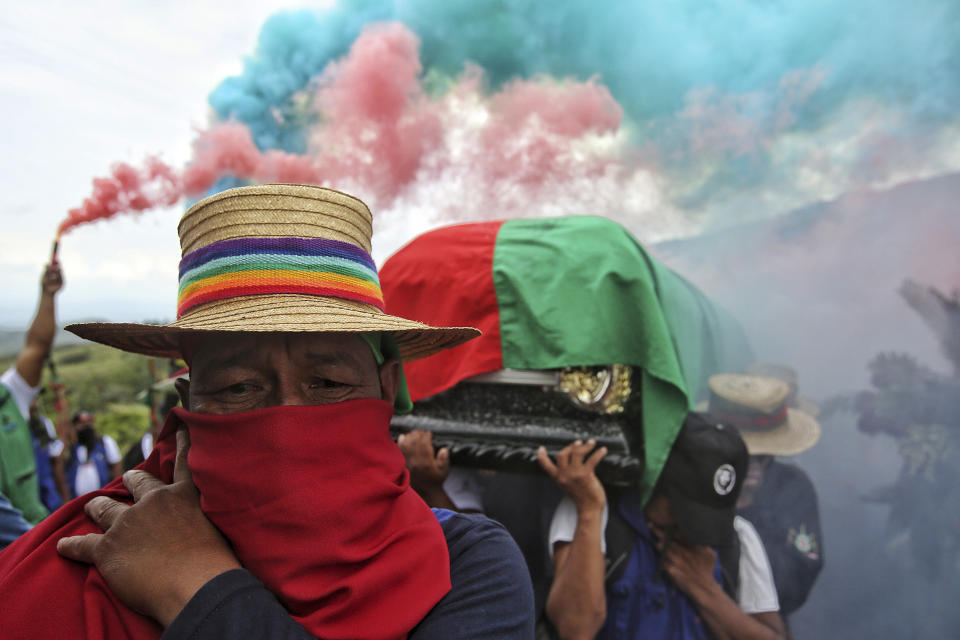 Members of the Indigenous Guard carry the coffin of Indigenous leader Albeiro Camayo in Buenos Aires, Colombia, Thursday, Jan. 27, 2022. Camayo was assassinated on Jan. 24 by an armed group that the Indigenous community says they believe are remnants of the former FARC rebel group. (AP Photo/Andres Gonzalez)