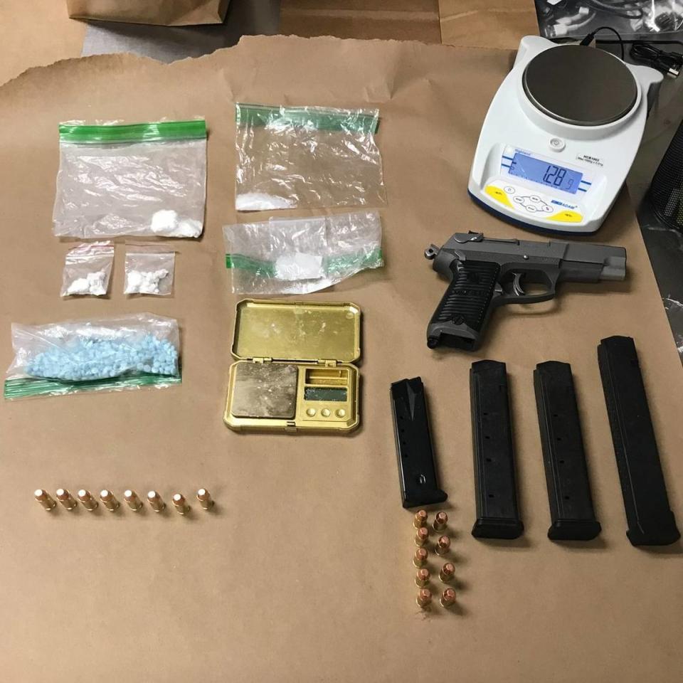 An image of items Olympia police recovered from a Lakewood man accused of robbing two convenience stores and burglarizing a coffee stand on March 11. The image includes a firearm and ammunition, as well as baggies of meth and fentanyl poweder and pills.