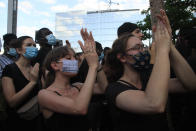 Protesters clap their hands outside the courthouse Tuesday, June 2, 2020 in Paris. Thousands of people defied a police ban and converged on the main Paris courthouse for a demonstration to show solidarity with U.S. protesters and denounce the death of a black man in French police custody. The demonstration was organized to honor Frenchman Adama Traore, who died shortly after his arrest in 2016, and in solidarity with Americans demonstrating against George Floyd's death. (AP Photo/Michel Euler)