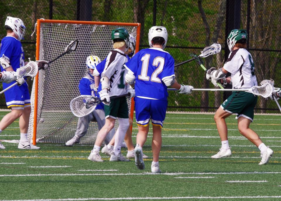 Hunter Grafton of Abington (far right) takes a shot through a Hull crowd that finds the net on goalie Sean Walsh early in the game on Tuesday, May 9, 2023. Grafton would have 3 goals to start the game, and continued scoring throughout.
