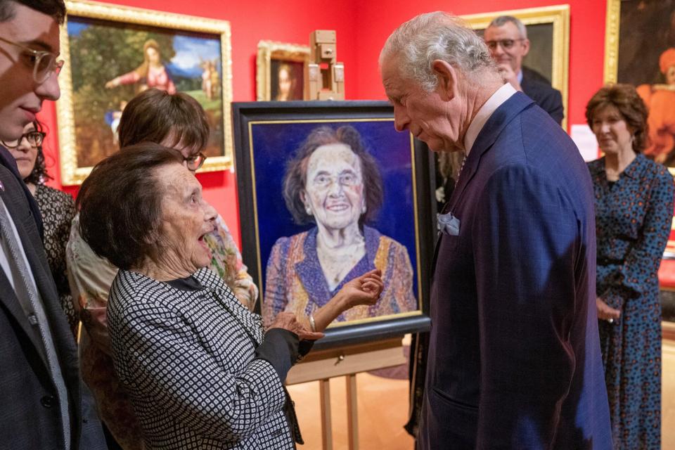 Britain's Prince Charles, Prince of Wales (3R) talks with Holocaust survivor Lily Ebert (L) as she stands alongside a portrait of herself, commissioned by The Prince of Wales to pay tribute to Holocaust survivors, during a display entitled 'Seven Portraits:Surviving the Holocaust' at The Queen's Gallery in Buckingham Palace, London on January 24, 2022. - The special display Seven Portraits: Surviving the Holocaust at The Queen's Gallery, Buckingham Palace has been commissioned by HRH The Prince of Wales to pay tribute to the stories of seven remarkable Holocaust survivors, each of whom has in recent years been honoured for services to Holocaust awareness and education.