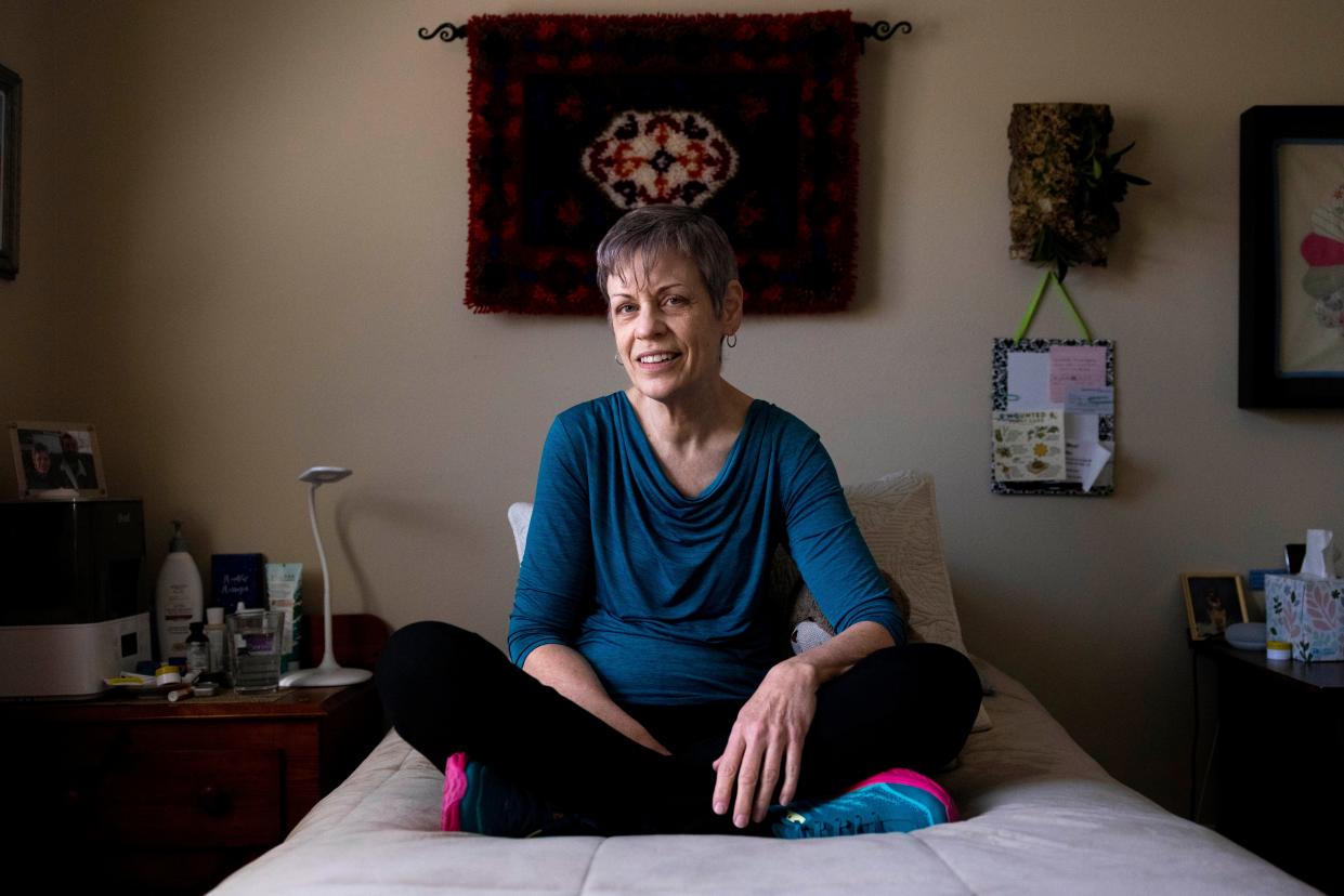 Marlene Mears sits for a portrait in the room she rents in Longmont, Colo. Mears has been a tenant at Becky Miller's home for over two years.