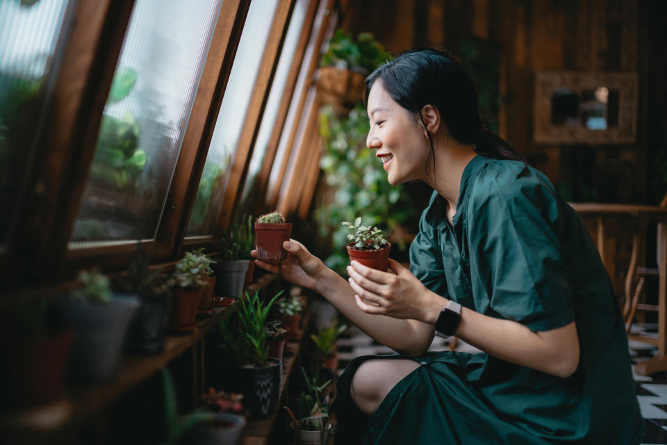 A woman is tending to her garden