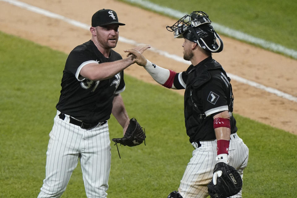 Chicago White Sox relief pitcher Liam Hendriks, left, celebrates with catcher Yasmani Grandal after the White Sox defeated the Toronto Blue Jays 5-2 in a baseball game in Chicago, Thursday, June 10, 2021. (AP Photo/Nam Y. Huh)