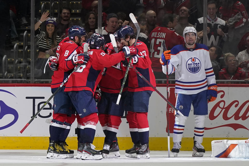 Members of the Washington Capitals celebrate Evgeny Kuznetsov's goal in the second period of an NHL hockey game against the Edmonton Oilers, Monday, Nov. 7, 2022, in Washington. (AP Photo/Patrick Semansky)