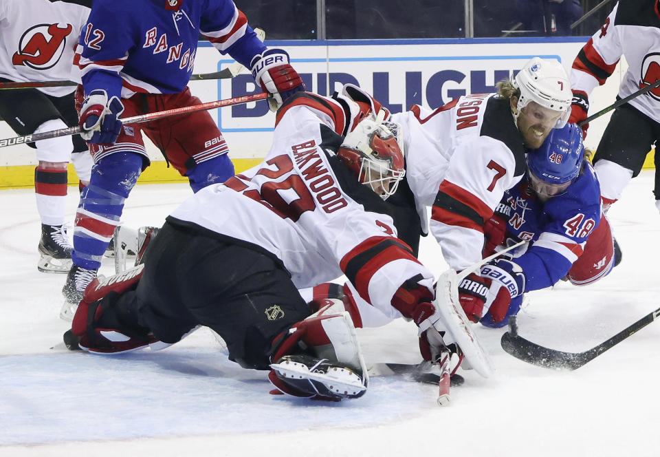 New Jersey Devils' Mackenzie Blackwood (29) and Matt Tennyson defend against New York Rangers' Brendan Lemieux, right, during the second period of an NHL hockey game Tuesday, Jan. 19, 2021, in New York. (Bruce Bennett/Pool Photo via AP)