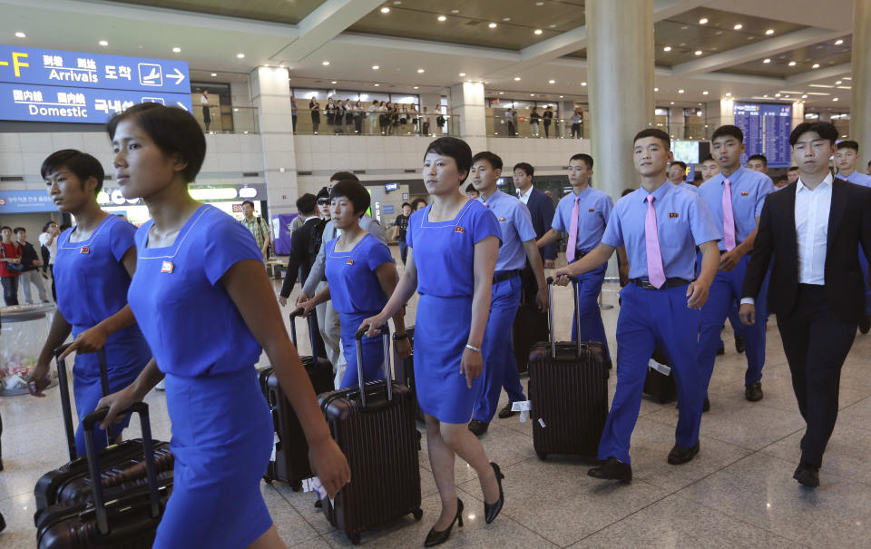 FILE - In this July 29, 2018, file photo, a North Korean delegation arrives for joint Asian Games training with South Koreans at Incheon International Airpot in Incheon, South Korea. The war-separated rivals will take their reconciliation steps to the Asian Games in Jakarta and Palembang, Indonesia, where they will jointly march in the opening ceremony and field combined teams in basketball, rowing and canoeing. (AP Photo/Ahn Young-joon, File)