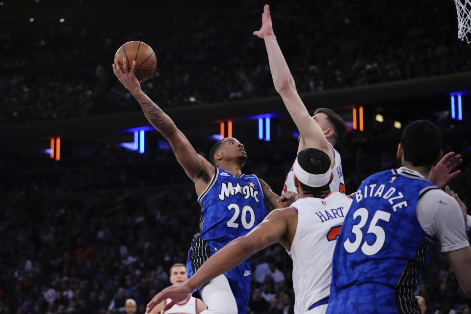 Orlando Magic's Markelle Fultz (20) looks to shoot over New York Knicks' Josh Hart, second from right, during the first half of an NBA basketball game Monday, Jan. 15, 2024, in New York. (AP Photo/Frank Franklin II)