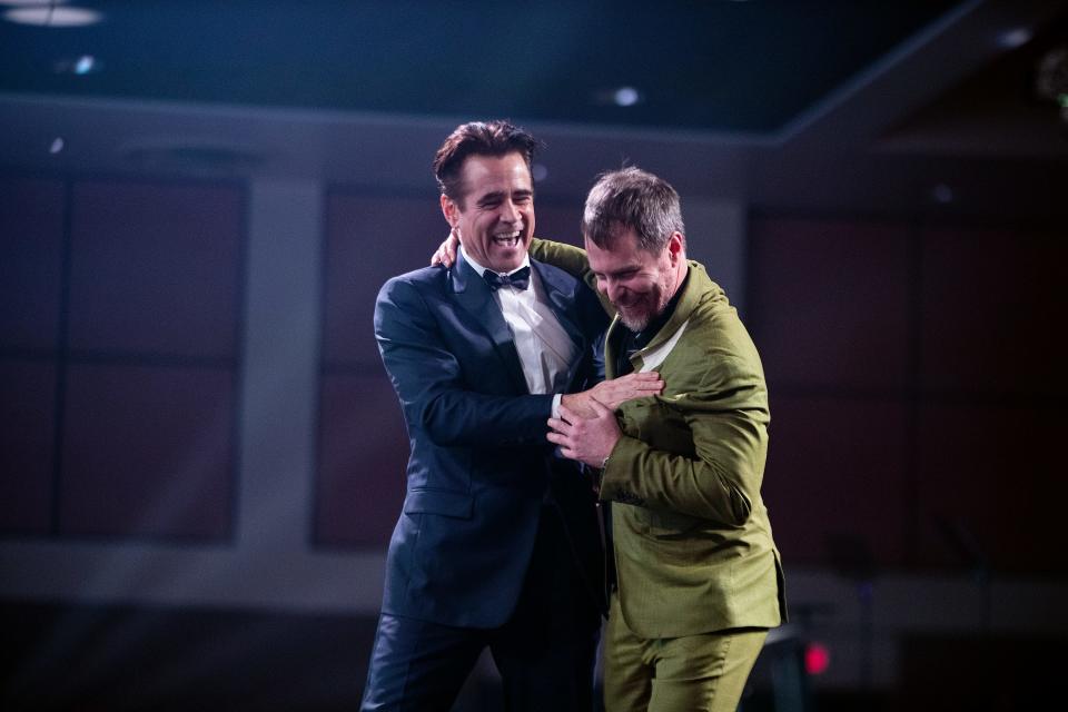 Colin Farrell and presenter Sam Rockwell laugh together after Farrell received the Desert Palm Achievement Award for his performance in "The Banshees of Inisherin" during the 34th Annual Palm Springs International Film Festival in Palm Springs, Calif., on Thursday, Jan. 5, 2023. 