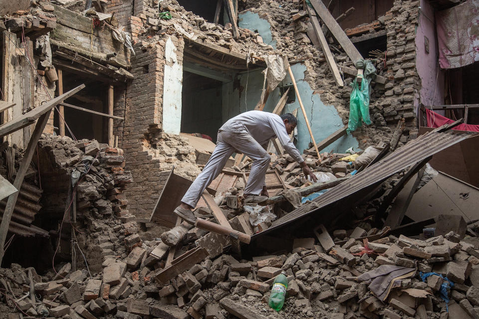 A man climbs on top of building debris after a <a href="http://www.huffingtonpost.com/2015/04/25/nepal-earthquake-avalanche_n_7141944.html">7.8-magnitude earthquake struck Nepal</a> and triggered a deadly avalanche on Mount Everest on April 25. The earthquake, which killed <a href="http://www.reuters.com/article/us-quake-nepal-idUSKBN0O20LL20150517">over 8,500 people</a>, was the worst to hit Nepal in over 80 years.