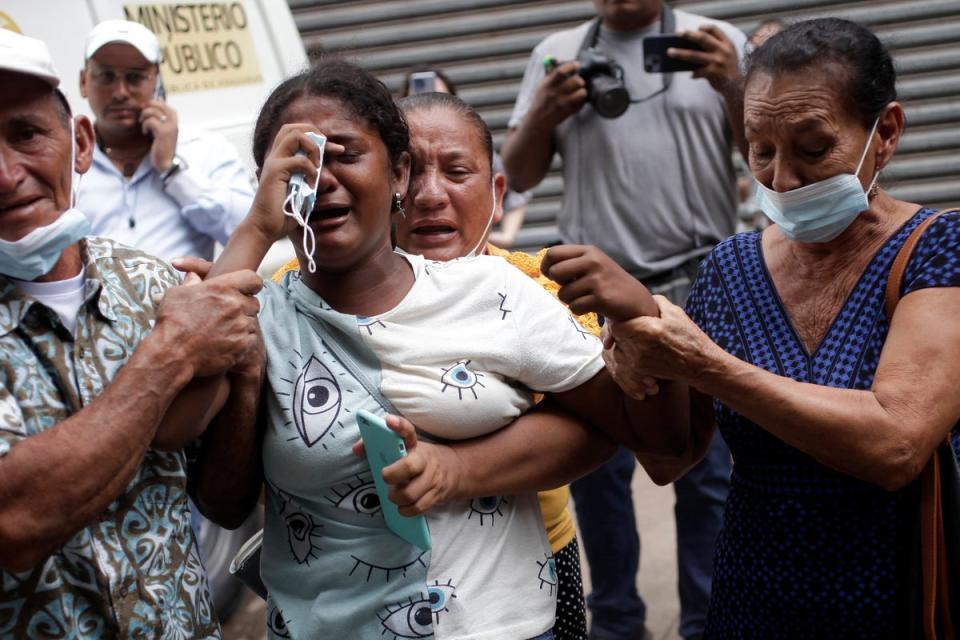 The relative of a victim of the deadly prison riot at the Centro Femenino de Adaptacion Social (CEFAS) women’s prison is comforted as she reacts outside a morgue in Tegucigalpa (REUTERS)