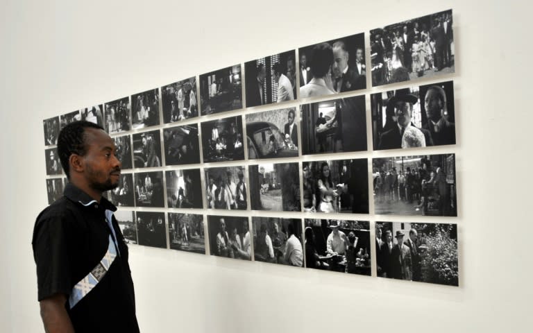 A man looks at photo taken by Nigerian photographer Uche Okpa-Iroha at the Modibo Keita museum in Mali's capital Bamako on November 5, 2015