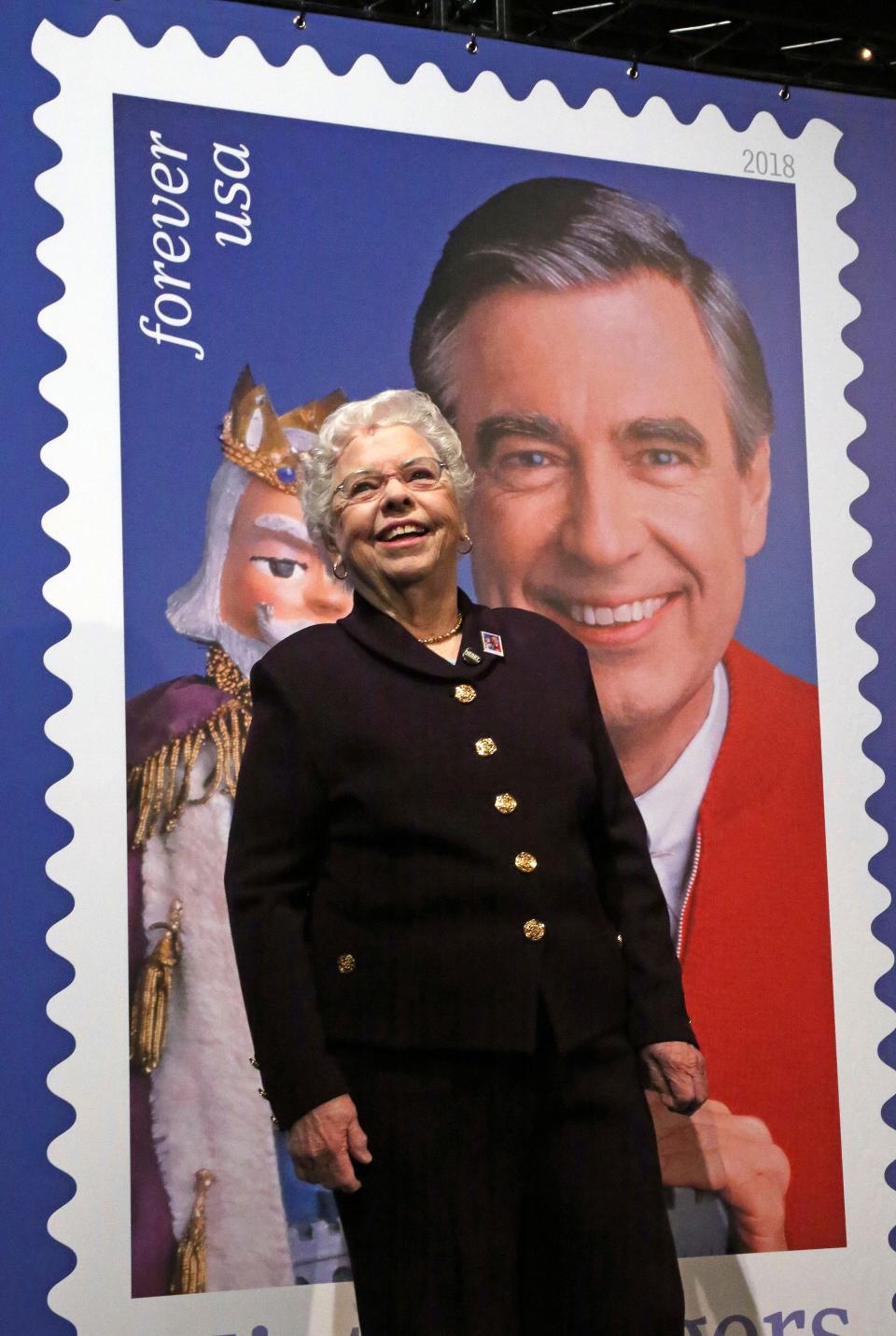 Fred Rogers' wife, Joanne, stands in front of a giant Mister Rogers Forever Stamp following the day-of-issue dedication in WQED's Fred Rogers Studio in Pittsburgh.