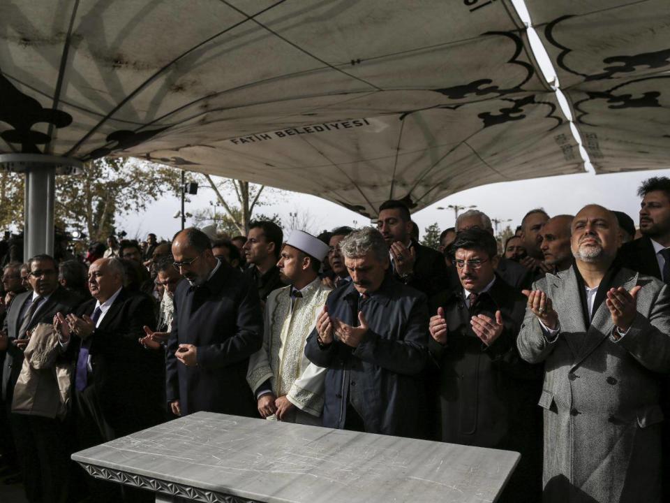Mourners gather before an empty funeral slab to perform an absentia burial ceremony for Jamal Khashoggi (Tara Todras-Whitehill)