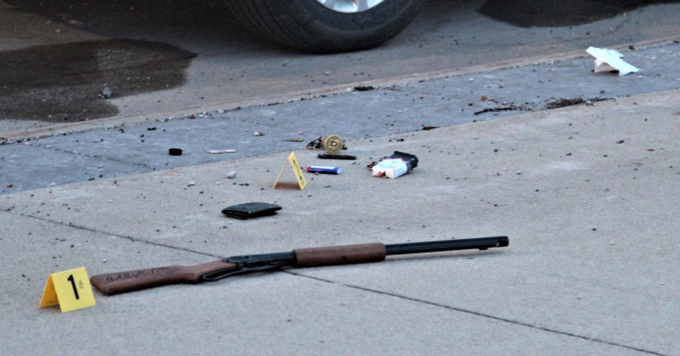 Items on the sidewalk at the scene of an officer-involved shooting at the foot of the Sixth Street bridge early Wednesday, April 7, 2021, in Waterloo, Iowa. In a lawsuit filed Thursday, Sept. 23, 2021, a man who was paralyzed when an Iowa police officer shot him in April is suing the officer. Marcelino Alvarez-Victoriano contends the shooting was not justified. Authorities say a Waterloo police officer shot Alvarez-Victoriano after he pointed a pellet gun that looked like a shotgun at two Black Hawk County sheriff's deputies. (Jeff Reinitz/The Courier via AP)