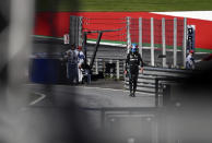 Mercedes driver George Russell of Britain walks back to his pits after he crashed into the track wall during a qualifying session at the Red Bull Ring racetrack in Spielberg, Austria, Friday, July 8, 2022. The Austrian F1 Grand Prix will be held on Sunday July 10, 2022. (Christian Bruna/Pool via AP)