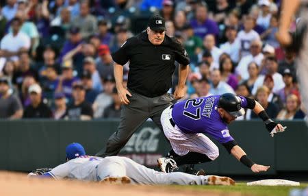 Jun 18, 2018; Denver, CO, USA; Colorado Rockies shortstop Trevor Story (27) is called out by first base umpire Bill Welke (3) in the fourth inning at Coors Field. Mandatory Credit: Ron Chenoy-USA TODAY Sports