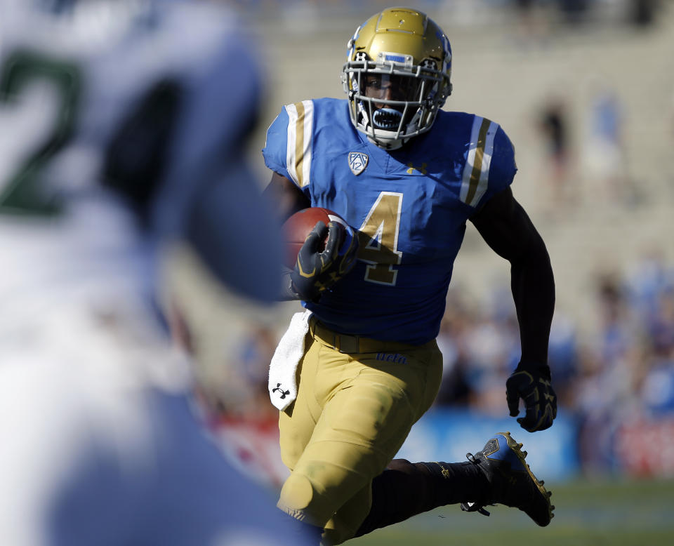 UCLA running back Bolu Olorunfunmi has discovered he can get into the end zone by using defenders as a trampoline. (AP Photo)