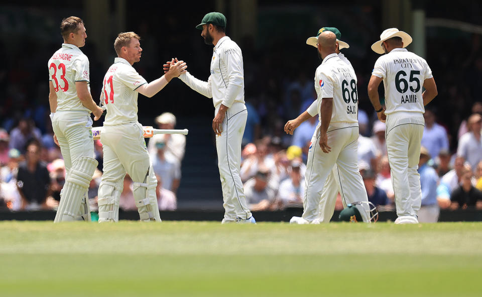 Shan Masood, pictured here congratulating David Warner.