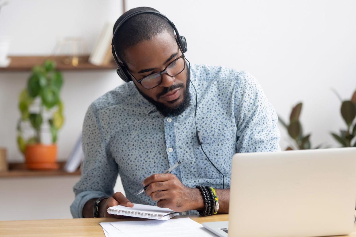 Man with headphones on his laptop