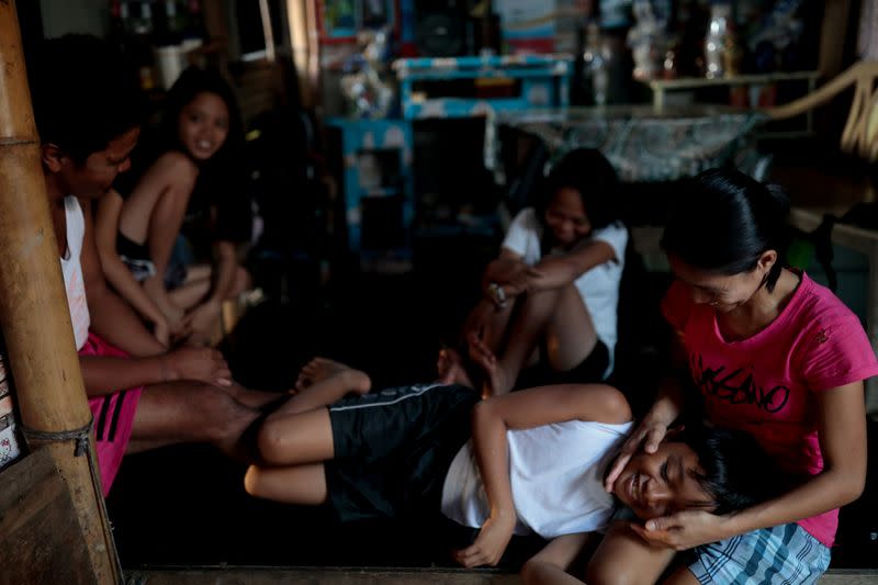 The Wider Image: Rising seas threaten early end for sinking village in Philippines