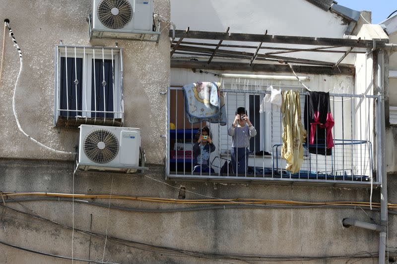 Kids play on their balcony in Bnei Brak as Israel enforces a lockdown of the ultra-Orthodox Jewish town badly affected by coronavirus disease (COVID-19), Bnei Brak