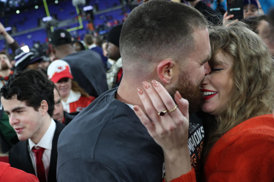 Travis Kelce #87 of the Kansas City Chiefs embraces Taylor Swift after a 17-10 victory against the Baltimore Ravens in the AFC Championship Game.