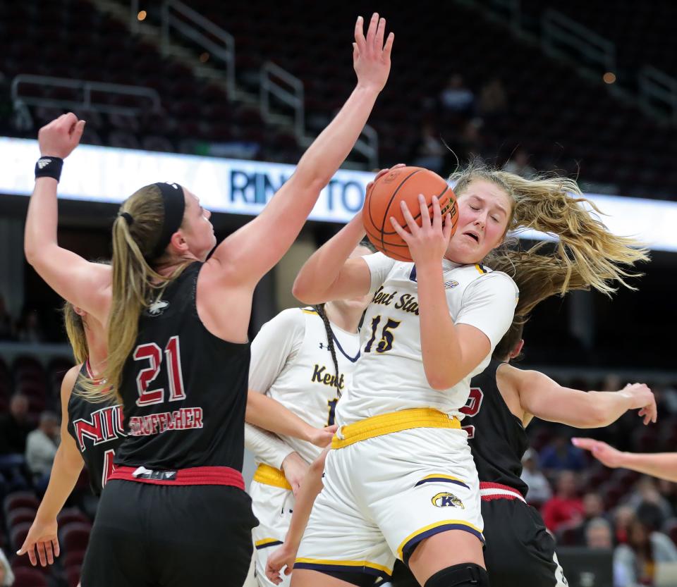 Kent State forward Bridget Dunn brings down a rebound against Northern Illinois forward Tara Stauffacher (21) during the second half of the Mid-American Conference Tournament quarterfinals, Wednesday, March 13, 2024, in Cleveland.