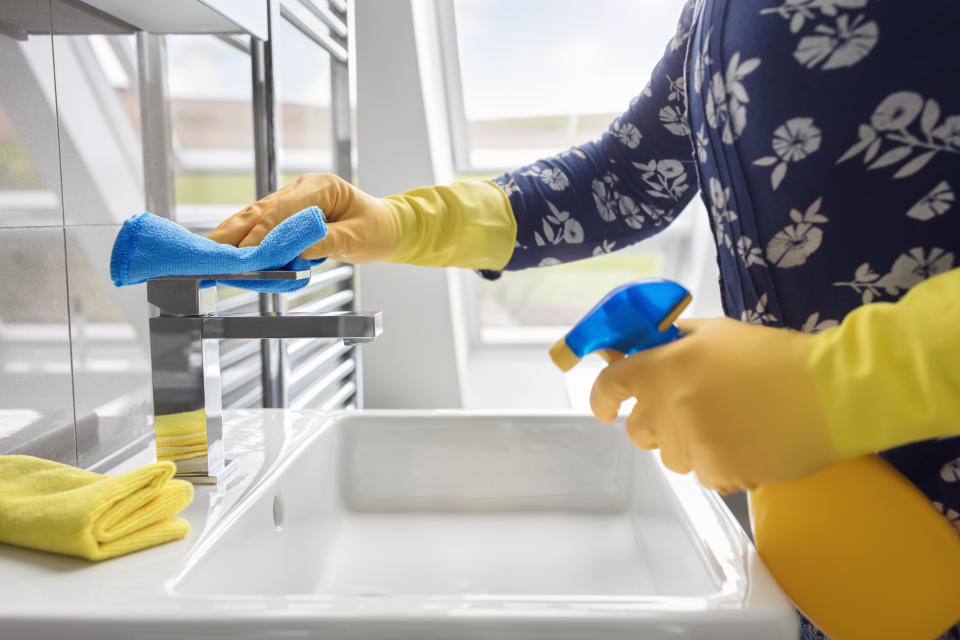 Cleaning sink and faucet with antibacterial detergent, coronavirus prevention