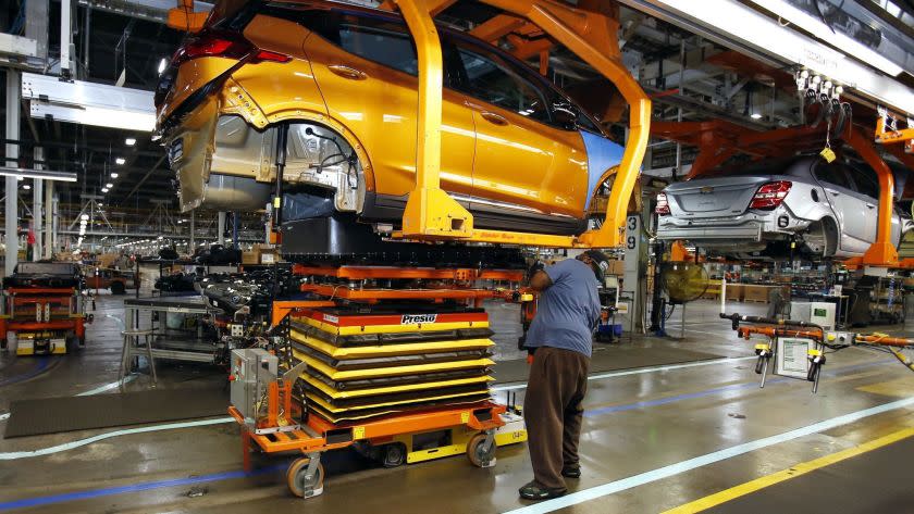 A battery is lifted into place for installation in the Chevrolet Bolt EV at the General Motors Orion Assembly plant Friday, Nov. 4, 2016, in Orion Township, Mich. The Chevrolet Bolt can go more than 200 miles on battery power and will cost less than the average new vehicle in the U.S. But it's unclear whether the car can do much to shift America from gasoline to electricity in an era of $2 prices at the pump. (AP Photo/Duane Burleson)