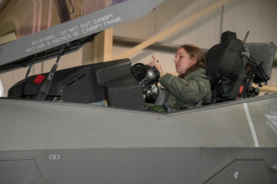 Thompson dons her helmet recently prior to a mission at Al Dhafra Air Base, United Arab Emirates