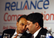 Chairman of Reliance Anil Dhirubhai Ambani Group, Anil Ambani (L) chats with Indian Minister of Communications and IT Dayanidhi Maran (R) at the launch of the FALCON Submarine Cable system in New Delhi, 05 September 2006. Reliance Communications owned Falcon with its undersea cable connecting five Middle East countries as well as Sudan and Egypt, announced commercial operation of the cable after Union IT and Communications Minister Dayanidhi Maran made the first call, unleashing international bandwidth between India, Middle East and Europe. The 2.56 terabit FALCON submarine cable system will connect 11 countries on its entire length of 11,859 km from Mumbai to Egypt. AFP PHOTO/Prakash SINGH
